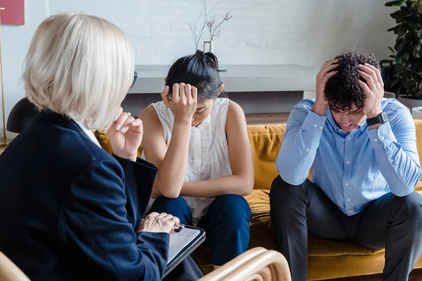 A couple in a therapy session, sitting close and engaged in conversation